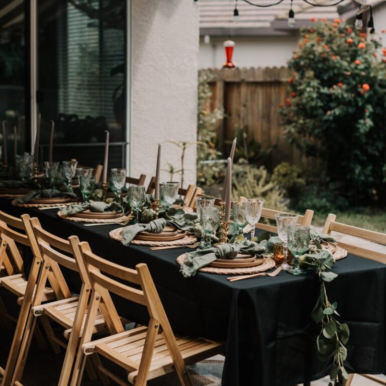 Long table with black linens and wooden folding chairs