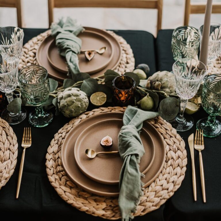 Place setting with greenery and glassware