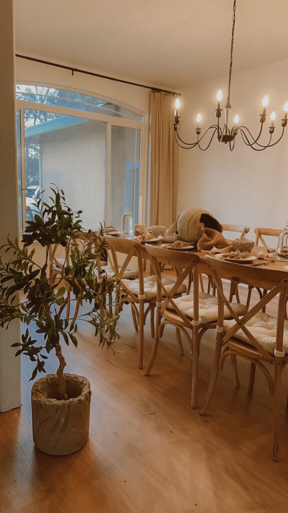 Dining room set with cross-back chairs and a chandelier