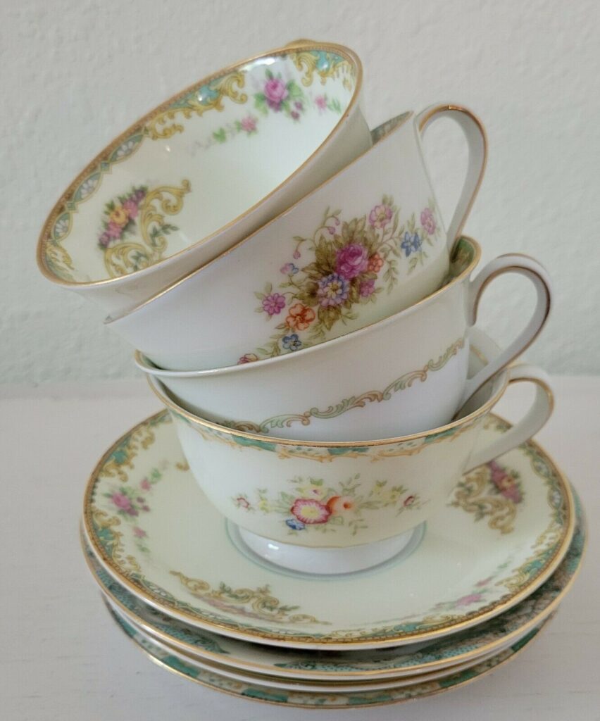 Stacked vintage floral teacups and saucers